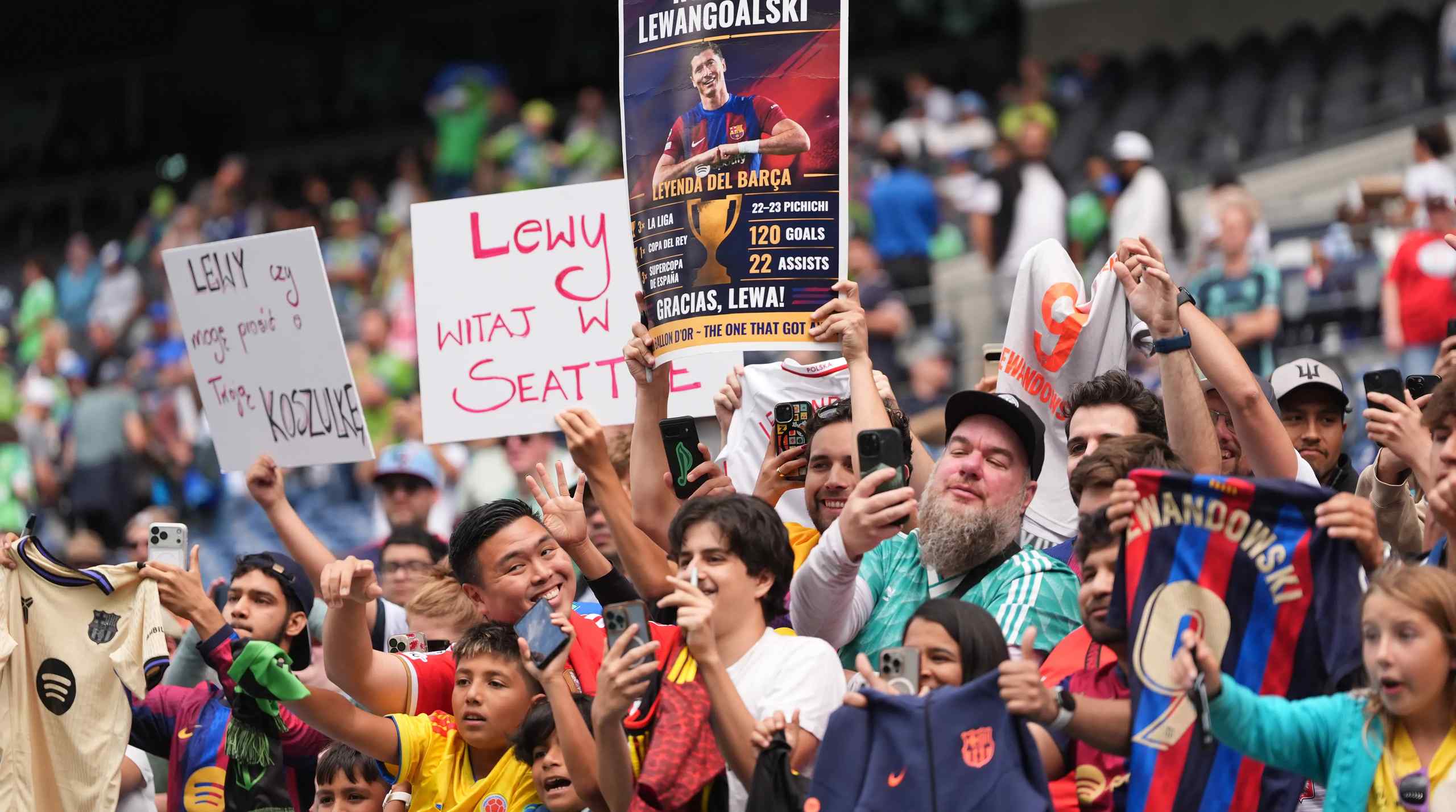 MLS soccer fans holding up a Robert Lewandowski sign.
